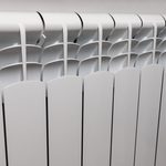 Central,Heating,System.,Modern,Radiator,On,White,Wall,Indoors.
